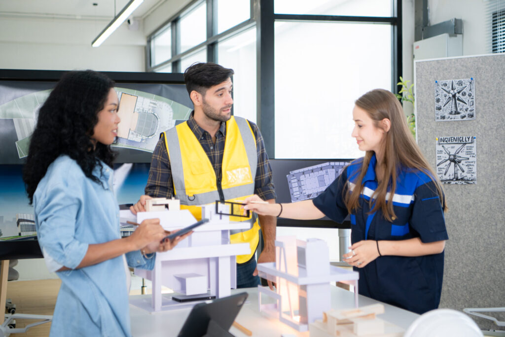 Engineers, architects, and designers collaborate to design a building construction for a commercial client